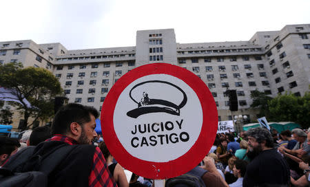 A sign that reads "Judgement and punishment" is seen outside a courthouse where the sentence hearing of the five-year trial for the role of Navy officers during the 1976-1983 dictatorship is being held, in Buenos Aires, November 29, 2017. REUTERS/Marcos Brindicci