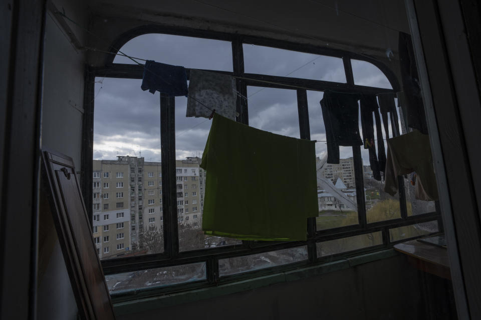 Clothes hang to dry in the apartment where the Shlapak family, who are internally displaced from Kharkiv, took refuge, in Lviv, western Ukraine, Sunday, April 3, 2022. On the first day of Russia's invasion, the family left to seek safety in a subway, leaving them homeless for seven days, along with hundreds of other residents. (AP Photo/Nariman El-Mofty)