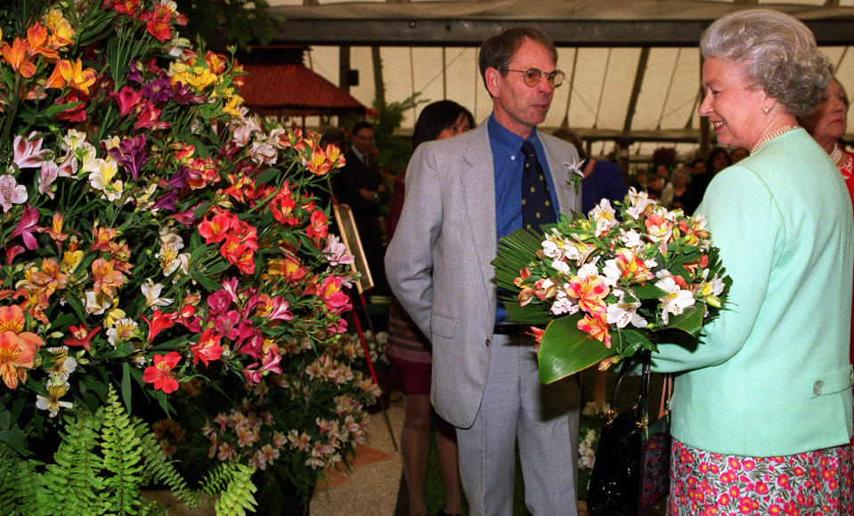 The Queen is given a preview of flowers chosen for the wedding of her son, Prince Edward, to Sophie Rhys-Jones. The Queen was shown the lillies in a giant floral display as she attended the Chelsea Flower Show.   (Photo by Fiona Hanson - PA Images/PA Images via Getty Images)