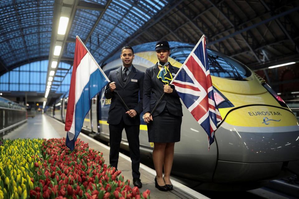 Eurostar employees hold the Union and Dutch flag in front of train bound for Amsterdam: REUTERS