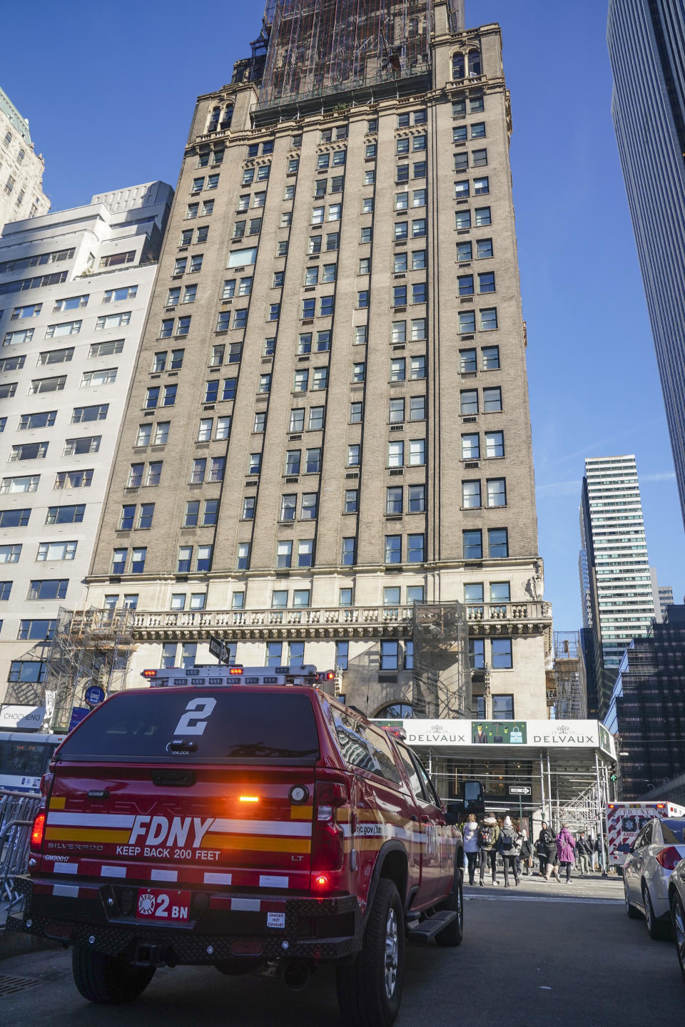 A fire department vehicle is parked outside the Sherry Netherland hotel, center, after an earlier fire on the same floor as the penthouse residence of Chinese businessman Guo Wengui, who has been arrested on charges alleging that he oversaw a $1 billion fraud conspiracy, Wednesday March 15, 2023, in New York. (AP Photo/Bebeto Matthews)