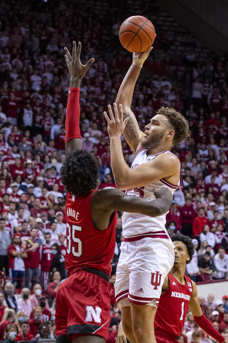 Indiana forward Race Thompson (25) shoots over Nebraska center Eduardo Andre (35) during the second half of a NCAA college basketball game, Saturday, Dec. 4, 2021, in Bloomington, Ind. (AP Photo/Doug McSchooler)