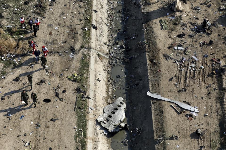 FILE - In this Jan. 8, 2020, file photo, rescue workers search the scene where a Ukrainian plane crashed in Shahedshahr, southwest of Tehran, Iran. Sweden’s Foreign Minister Ann Linde said Thursday, July 1, 2020 that Iran had agreed to compensate the families’ of the foreign victims of a Ukrainian passenger plane that was shot down outside Tehran in January. (AP Photo/Ebrahim Noroozi, File)