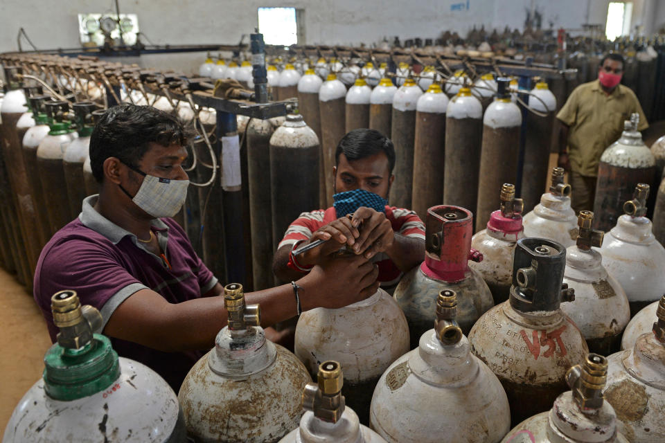 At a facility on the outskirts of Chennai on April 24, workers check medical oxygen cylinders that will be transported to hospitals.<span class="copyright">Arun Sankar—AFP/Getty Images</span>
