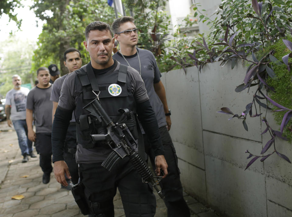 Civil police officers arrive to the Civil Police headquarters in Rio de Janeiro, Brazil, Tuesday, March 12, 2019. Police in Brazil have arrested two suspects in the killing of Rio de Janeiro councilwoman Marielle Franco and her driver. The brazen assassination of the two on March 14 last year led to massive protests and widespread anger in Latin America's largest nation. (AP Photo/Silvia Izquierdo)