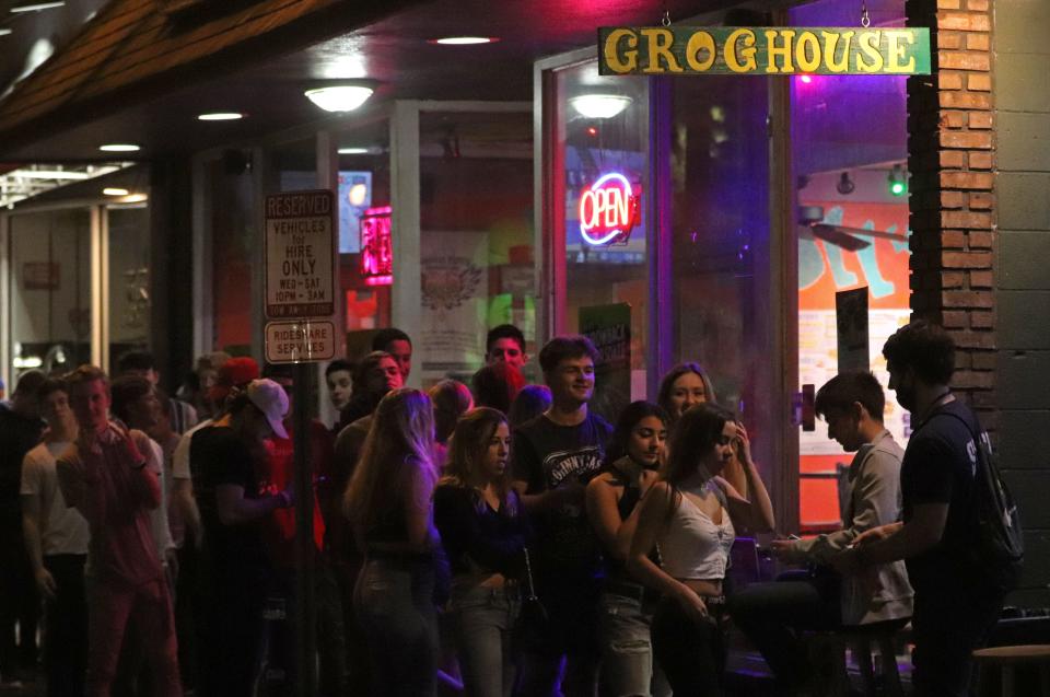People wait in line outside Grog House Grill at Midtown in Gainesville.
