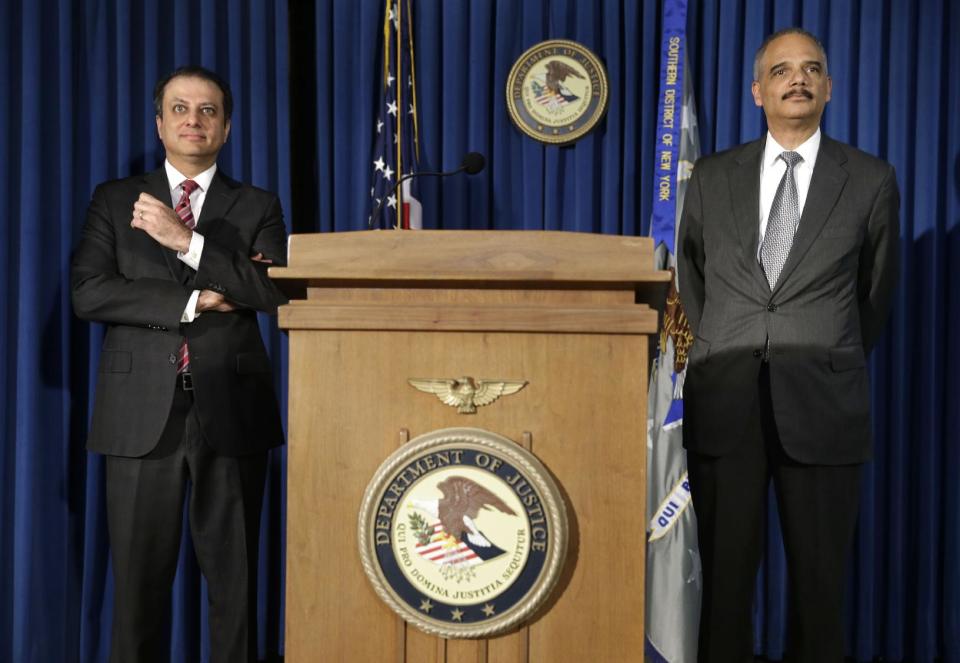 U.S. Attorney General Eric Holder, right, and U.S. Attorney for the Southern District of New York Preet Bharara take questions from reporters during a news conference in New York, Tuesday, April 1, 2014. Holder says the successful prosecution of Osama bin Laden's son-in-law in New York shows terror trials can be safely held in the United States.(AP Photo/Seth Wenig)