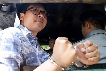 Detained Reuters journalist Wa Lone is escorted by police for a court hearing in Yangon, Myanmar January 23, 2018. REUTERS/Stringer