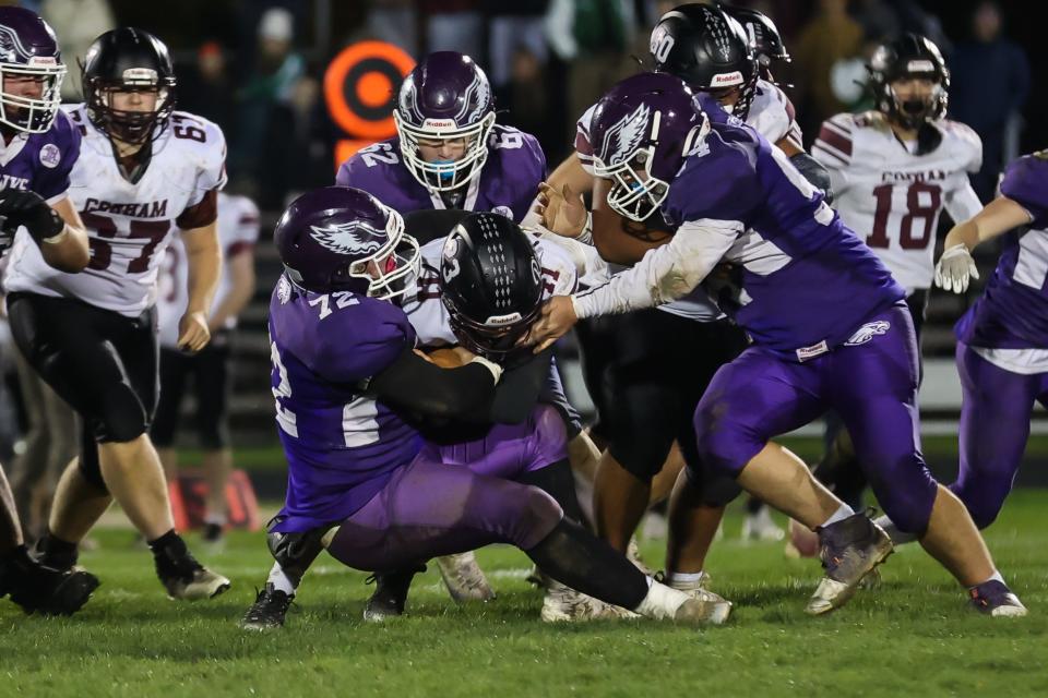 Marshwood's Riley Parnham pulls down Gorham running back Izak Young with the help of teammates Shane Waterman (62) and Daniel Mercier (54) during a Class B South quarterfinal game in South Berwick, Maine.Parnham was named the Class B Offensive Player of the Year.