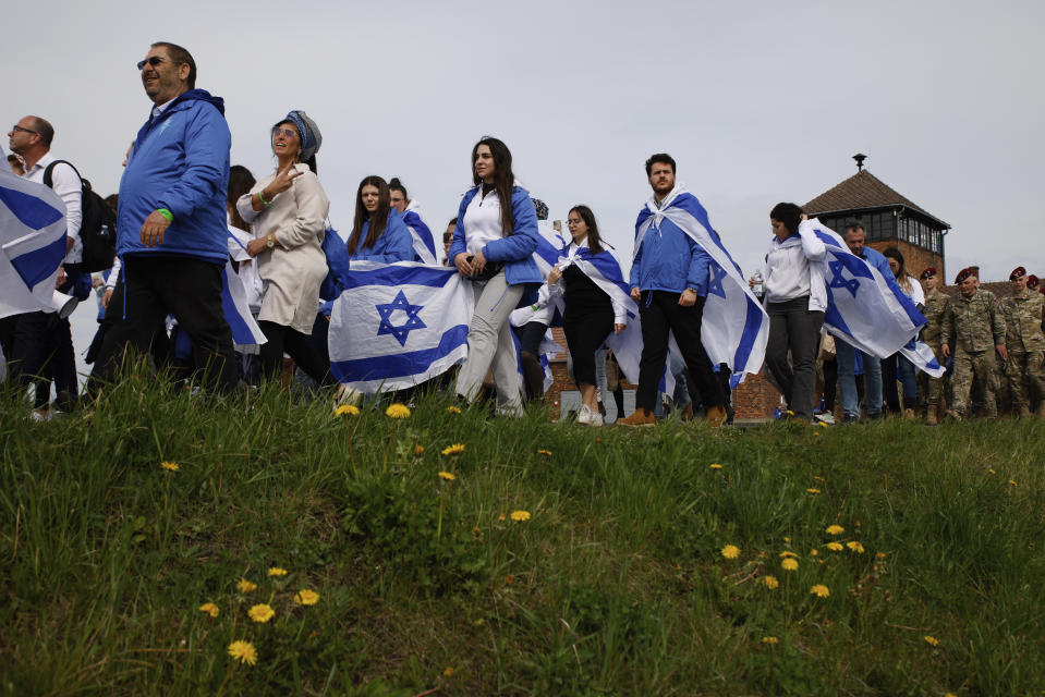 People participate in the annual 'March of the Living', a trek between two former Nazi-run death camps, in Oswiecim, Poland, Tuesday, April 18, 2023 to mourn victims of the Holocaust and celebrate the existence of the Jewish state. (AP Photo/Michal Dyjuk)