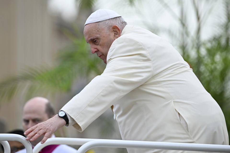 Pope Francis steps down of the popemobile before celebrating the Palm Sunday's mass in St. Peter's Square at The Vatican Sunday, April 2, 2023 a day after being discharged from the Agostino Gemelli University Hospital in Rome, where he has been treated for bronchitis, The Vatican said. The Roman Catholic Church enters Holy Week, retracing the story of the crucifixion of Jesus and his resurrection three days later on Easter Sunday. (AP Photo/Filippo Monteforte, pool)