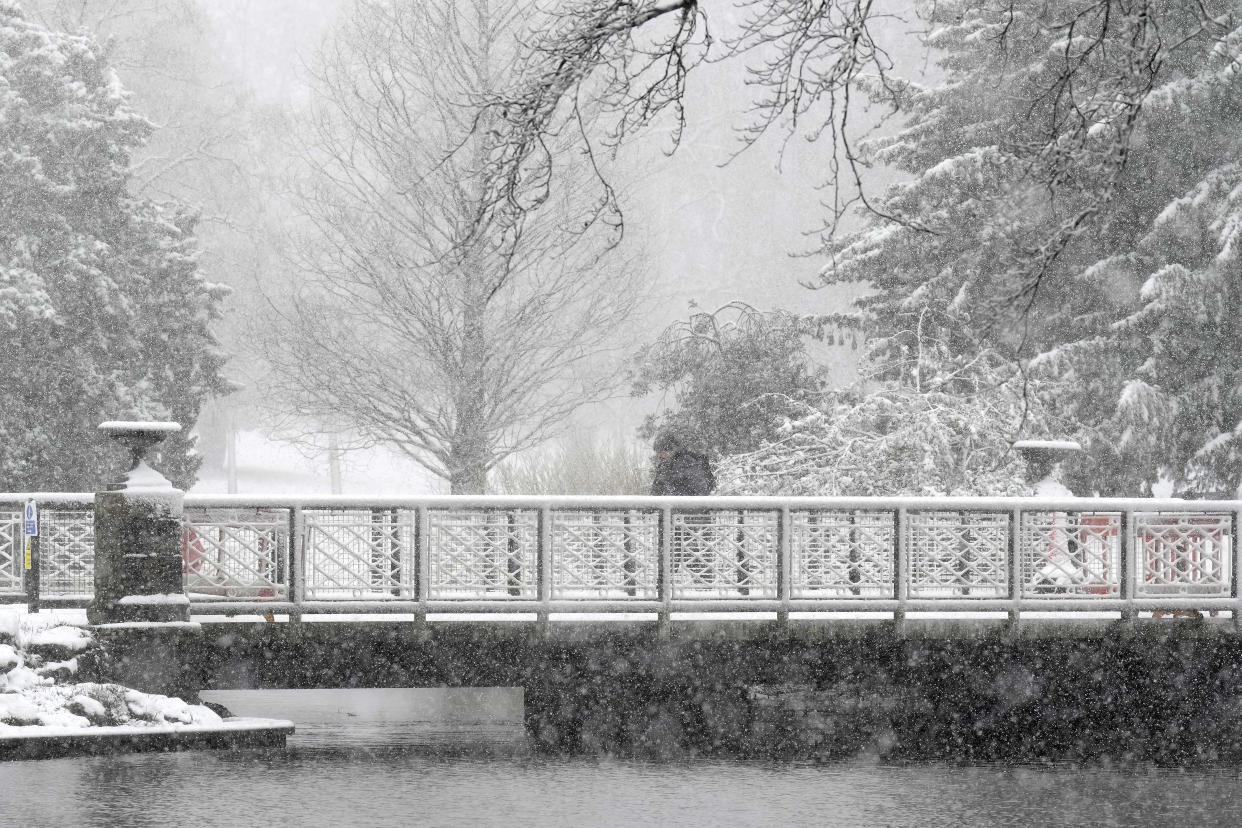 BUXTON, UNITED KINGDOM - FEBRUARY 08: People walk through the snow in Pavilion Gardens on February 08, 2024 in Buxton, United Kingdom. The Met Office issued two amber warnings for snow and ice, coinciding with rain and sleet, as cold air streams in from the Arctic into northern parts of the UK. (Photo by Christopher Furlong/Getty Images)