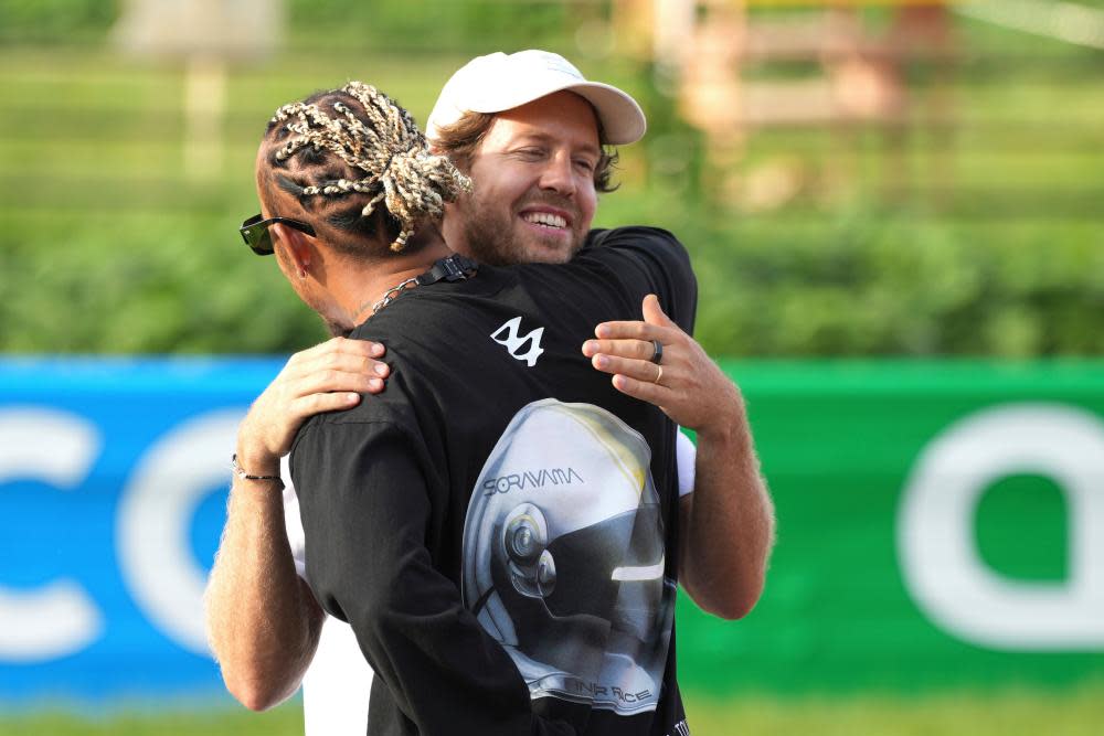 Sebastian Vettel greets Lewis Hamilton as they attend the project that aims to raise awareness for biodiversity.