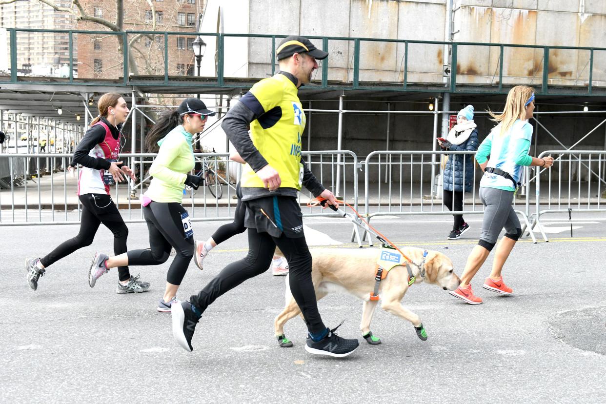 Guiding Eyes for the Blind President and CEO, Thomas Panek, runs the first ever 2019 United Airlines NYC Half Led Completely by Guide Dogs, with Gus on March 17, 2019 in New York City.