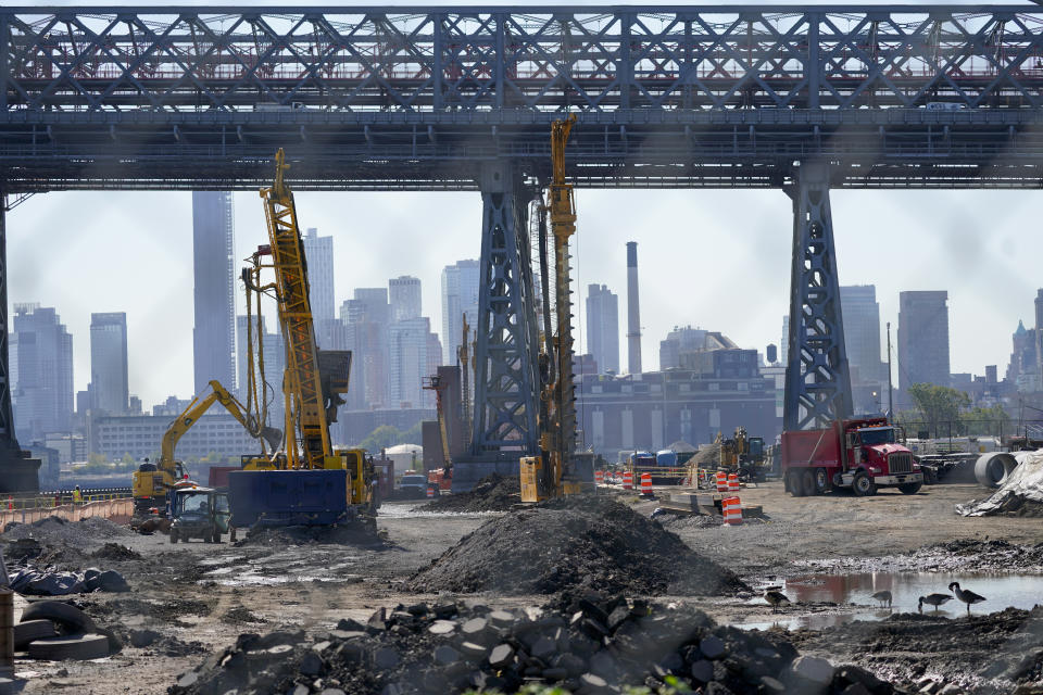 Heavy duty construction equipment are seen at the construction site of the East Side Coastal Resiliency Project at the East River Park, Friday, Oct. 7, 2022, in New York. After Superstorm Sandy struck the northeast U.S. in 2012, an unprecedented effort began to fortify the densely populated coastline against the next big storm. Then, last year, the region learned that even all those precautions might not be enough in an age of more powerful storms. (AP Photo/Mary Altaffer)