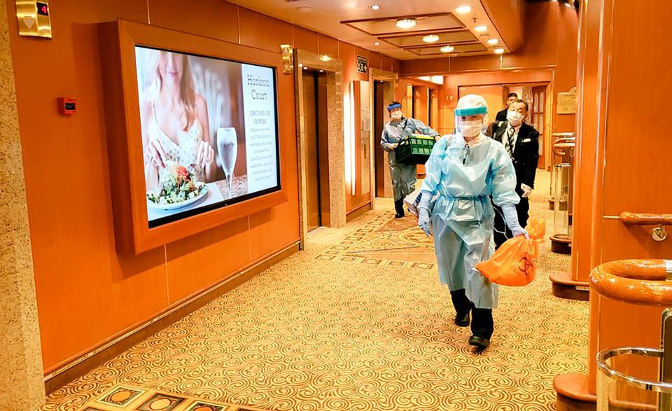 Medical workers in protective suits walk on the cruise ship Diamond Princess anchored off Yokohama, south of Tokyo, on Feb. 4, 2020.