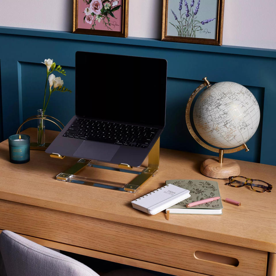 the gold-tone laptop riser featuring an acrylic base