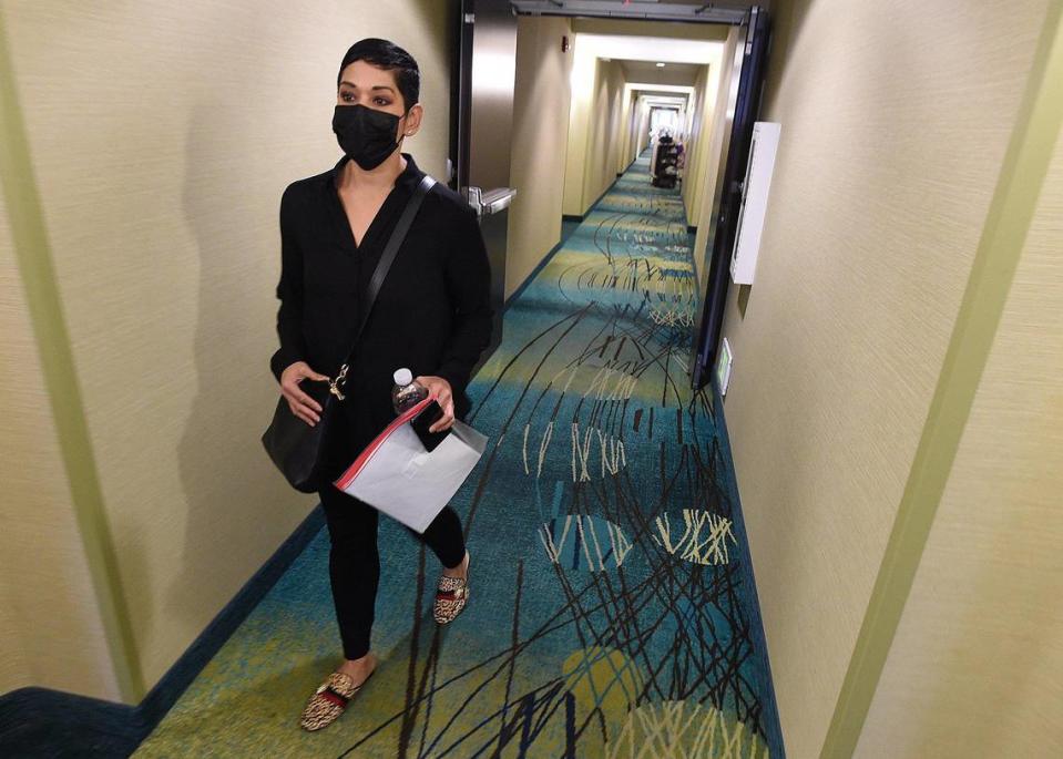 Randi Gonzales walks to her hotel room, which she has for eight months shared with with her mother, her two adult daughters, and two grandchildren, and their dog, Jan. 21, 2022. They were forced to move from their home of 38 years after the property owner died and his siblings sold the property.