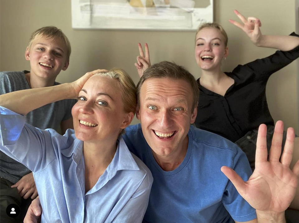 In this image taken from a video released on Dec. 31, 2020 by Russian opposition activist Alexei Navalny on his Instagram account, Russian opposition activist Alexei Navalny, foreground right, his wife Yulia, foreground left, his daughter Daria, right, and son Zakhar pose for a selfie. Russia’s prison service has asked a Moscow court to put top Kremlin critic Alexei Navalny behind bars for breaching the terms of his suspended sentence and probation. Navalny, who is convalescing in Germany from an August poisoning with a nerve agent that he has blamed on the Kremlin, alleged Tuesday Jan. 12, 2021, that Russian President Vladimir Putin was behind the new legal motion. (Navalny instagram account via AP)