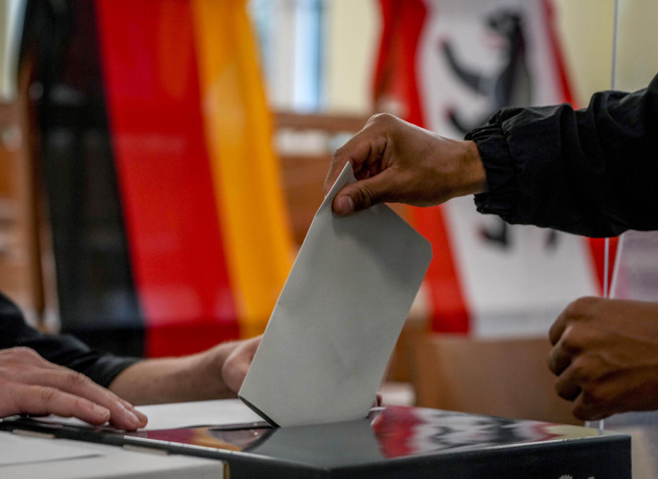 FILE - A man casts his ballot for the German elections in a polling station in Berlin, Germany, Sunday, Sept. 26, 2021. Germany’s Federal Constitutional Court has ordered the 2021 national election to be partially repeated in the German capital because of severe glitches at many polling stations. The court ruled Tuesday that the election must be repeated in 455 of 2,256 constituencies in the state of Berlin, which is one of three German cities that is also a state. (AP Photo/Michael Probst, File)