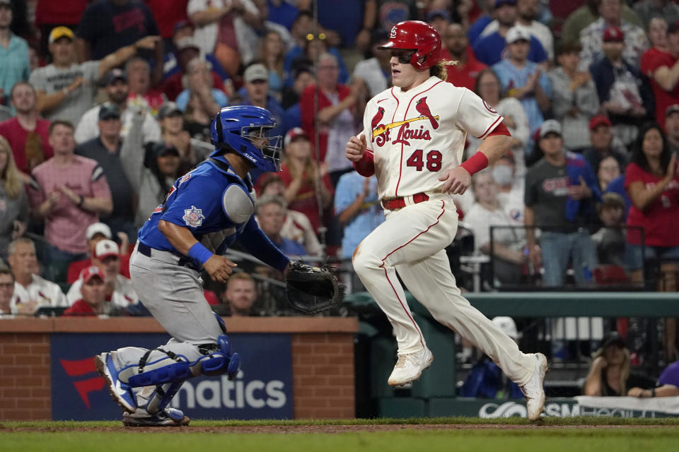 St. Louis Cardinals' Harrison Bader (48) scores past Chicago Cubs catcher Erick Castillo during the seventh inning of a baseball game Saturday, Oct. 2, 2021, in St. Louis. (AP Photo/Jeff Roberson)