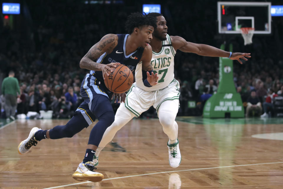 Memphis Grizzlies guard Ja Morant, left, drives past Boston Celtics forward Semi Ojeleye (37) during the first half of an NBA basketball game in Boston, Wednesday, Jan. 22, 2020. (AP Photo/Charles Krupa)