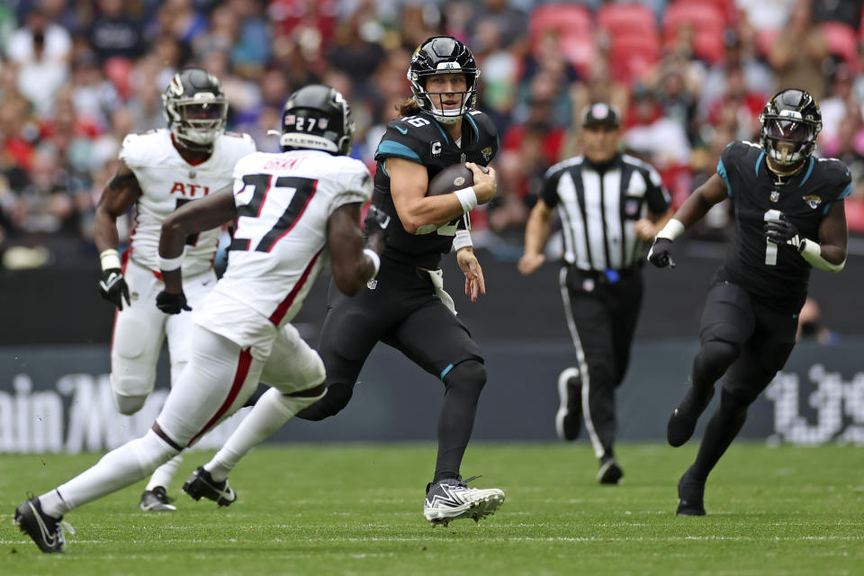 Jacksonville Jaguars quarterback Trevor Lawrence (16) runs with the ball during the first quarter of an NFL football game between the Atlanta Falcons and the Jacksonville Jaguars at Wembley stadium in London, Sunday, Oct. 1, 2023. (AP Photo/Ian Walton)