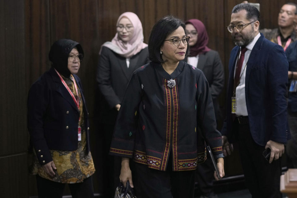 Indonesian Finance Minister Sri Mulyani Indrawati, center, and Social Affairs Minister Tri Rismaharini, left, arrive to attend a hearing on the presidential election result dispute at the Constitutional Court in Jakarta, Indonesia, Friday, April 5, 2024. (AP Photo/Dita Alangkara)
