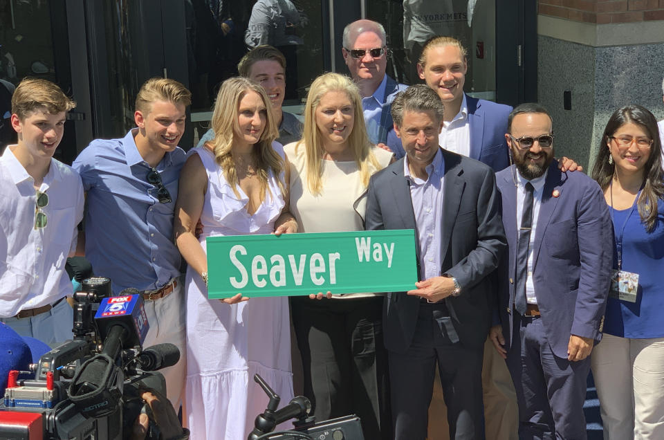 Anne Seaver, third from left, and her sister, Sarah Seaver, daughters of former New York Mets pitcher Tom Seaver, hold a street sign with New York Mets owner Jeff Wilpon, third from right, outside Citi Field in New York, Thursday, June 27, 2019. Others are unidentified. Tom Seaver is getting a statue outside the Mets' home, and the team is getting a new address. The announcement was made official at a ceremony Thursday. Citi Field will now be listed as 41 Seaver Way in honor of the Hall of Fame pitcher's number. New York City officials agreed to the team's request to rename the 126th Street address.(AP Photo/Avery Yang)