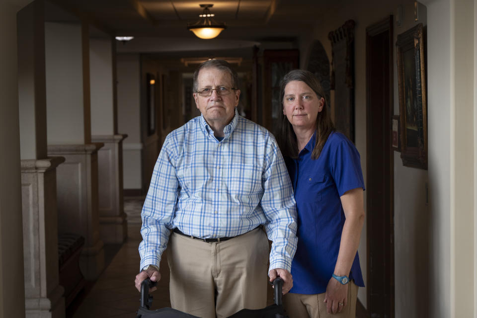 William Bortz, left, stands alongside his daughter, Ave Williams, at his senior living center, Friday, May 17, 2024, in San Diego. Bortz said criminals stole his family's nest egg of almost $700,000 in an elaborate scheme. Sophisticated overseas criminals are stealing tens of billions of dollars from Americans every year, a crime wave that's projected to get worse as the U.S. population ages and technology like AI makes it easier than ever to perpetrate fraud and get away with it. (AP Photo/Gregory Bull)