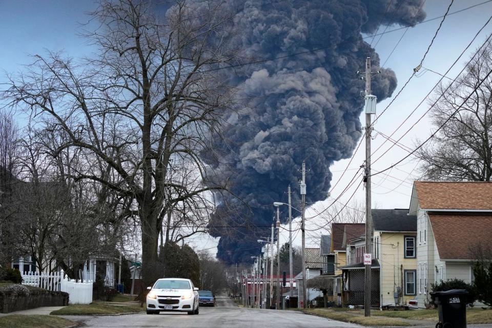 A black plume rises over East Palestine, Ohio, as a result of a controlled detonation of a portion of the derailed Norfolk Southern trains (AP)