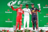 Formula One - F1 - Chinese Grand Prix - Shanghai, China - 09/04/17 - Winner Mercedes driver Lewis Hamilton of Britain celebrates on the podium with Ferrari driver Sebastian Vettel of Germany and Red Bull Racing driver Max Verstappen of the Netherlands after the Chinese Grand Prix at the Shanghai International Circuit. REUTERS/Aly Song