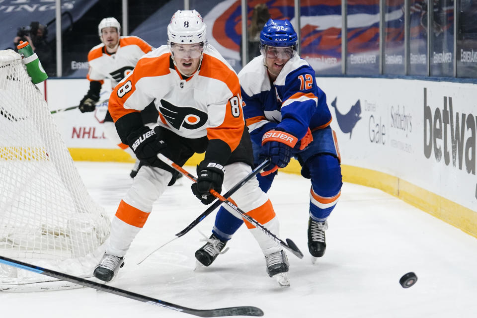 Philadelphia Flyers' Robert Hagg (8) fights for control of the puck with New York Islanders' Josh Bailey (12) during the second period of an NHL hockey game Thursday, April 8, 2021, in Uniondale, N.Y. (AP Photo/Frank Franklin II)