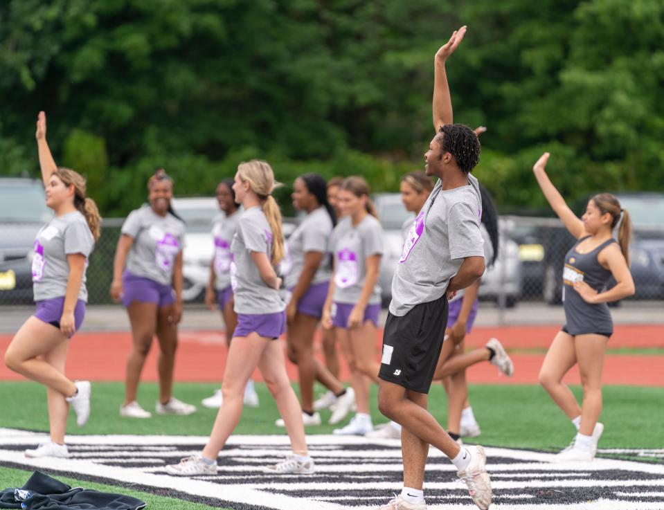 J.F. Kennedy’s Akiva Lewis-Allen (right) and his cheerleading teammates practiced Woodbridge High School on June 23 before the Marisa Rose Bowl charity All-Star game.