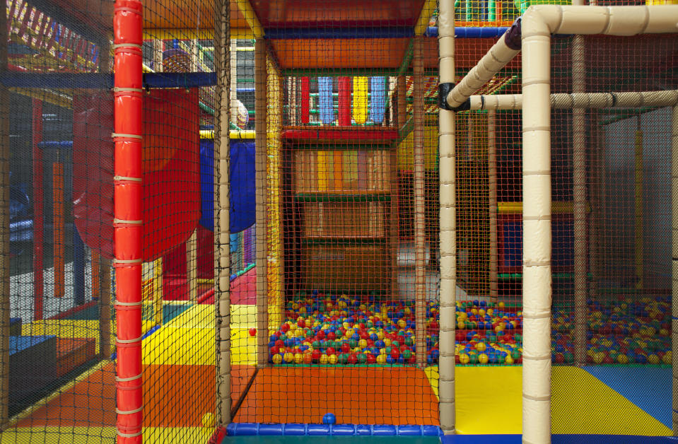 Indoor playground with climbing structures and ball pit