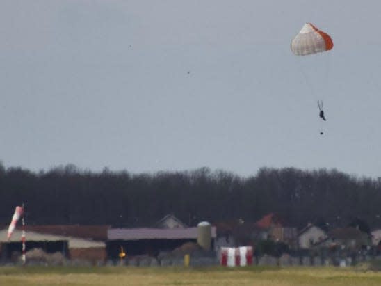 The man safely landing on the ground.