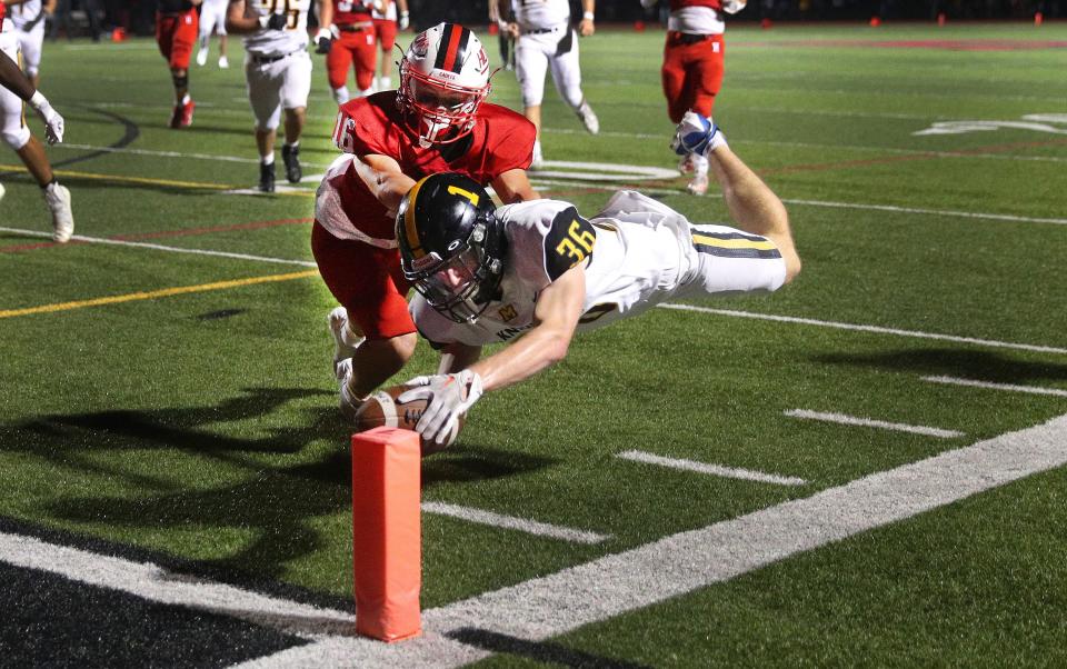 McQuaid running back Eoin Meyer dives to the pylon for a touchdown ahead of Hilton’s Brady Quill.