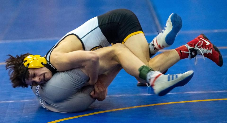 Quaker Valley's  Logan Richey, top, battles with Burgettstown's Dylan Slovick in the 113 lb. semifinal during the WPIAL AA  wrestling championships Saturday at Canon McMillan High School in Canonsburg.