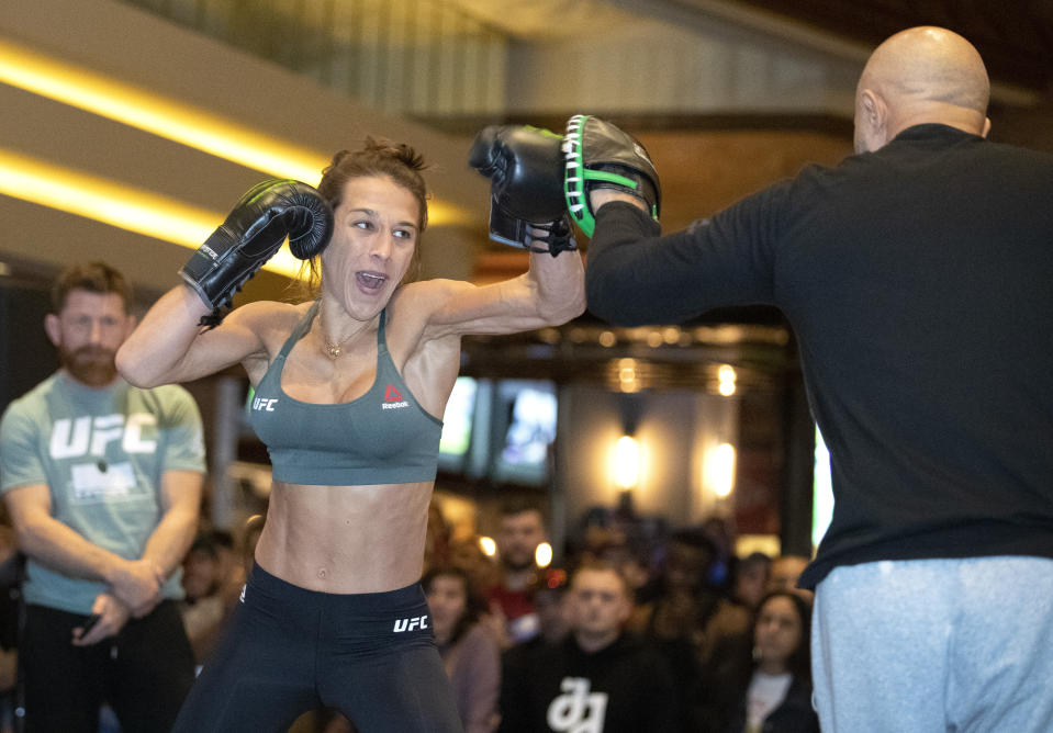 Former UFC women's strawweight champion Joanna Jedrzejczyk, of Poland, works on her timing with striking coach Mike Rodriquez during open workouts in Las Vegas on Wednesday, March 4, 2020, for her Saturday bout against Zhang Weili. (Steve Marcus/Las Vegas Sun via AP)