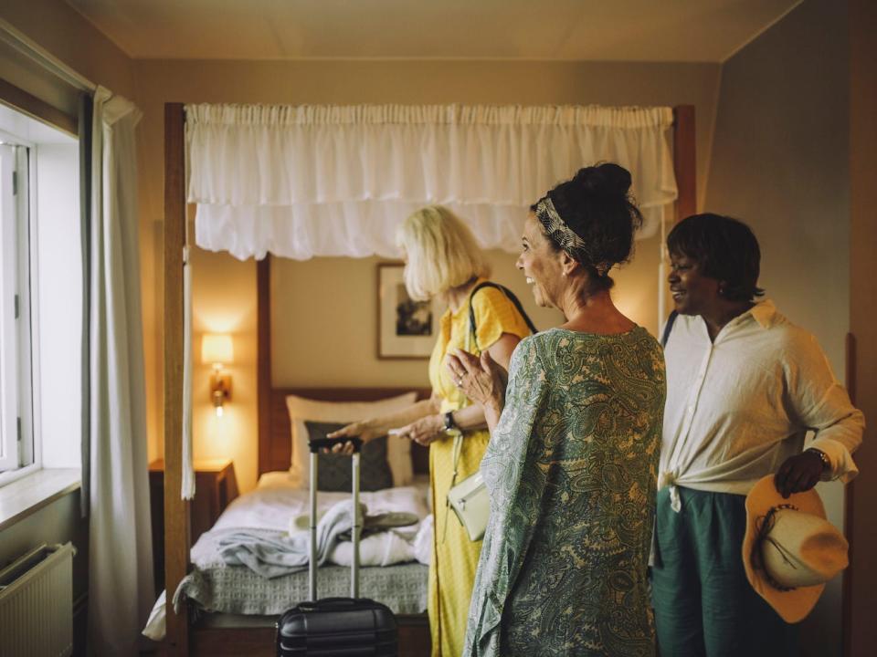 A group of travelers in their hotel room.