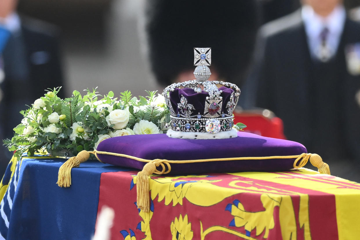 The coffin of Queen Elizabeth II, adorned with a Royal Standard and the Imperial State Crown is pulled by a Gun Carriage of The King's Troop Royal Horse Artillery, during a procession from Buckingham Palace to the Palace of Westminster, in London on September 14, 2022. - Queen Elizabeth II will lie in state in Westminster Hall inside the Palace of Westminster, from Wednesday until a few hours before her funeral on Monday, with huge queues expected to file past her coffin to pay their respects. (Photo by Daniel LEAL / various sources / AFP) (Photo by DANIEL LEAL/AFP via Getty Images)