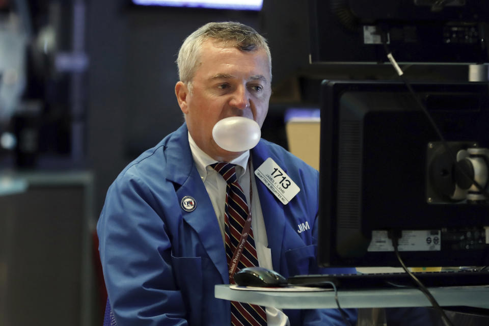 Trader James Lamb watches his screens as he works on the floor of the New York Stock Exchange, Monday, Aug. 12, 2019. Stocks are extending their losses at midday as investors opened the week heading for safety amid heightened anxiety over the U.S.-China trade war. (AP Photo/Richard Drew)