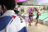 Swimmers train at the public swimming pool in the Paris-region town of Sevran, Wednesday, Jan. 24, 2024. The town of 51,000 people in the Seine-Saint-Denis region north of Paris is inheriting one of the pools that will be used for the Olympic and Paralympic Games in Paris this summer. The 50-meter pool Olympic pool for Sevran will be a significant upgrade. Its existing 25-meter pool is nearly 50 years old. (AP Photo/John Leicester)