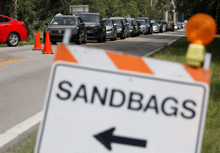 Motorists form a long queue to get sandbags at Kissimmee, in preparation for the arrival of Hurricane Irma making landfall, in Florida, U.S. September 7, 2017. REUTERS/Gregg Newton