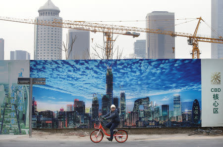A man cycles outside the construction sites in Beijing's central business area, China January 18, 2019. Picture taken January 18, 2019. REUTERS/Jason Lee
