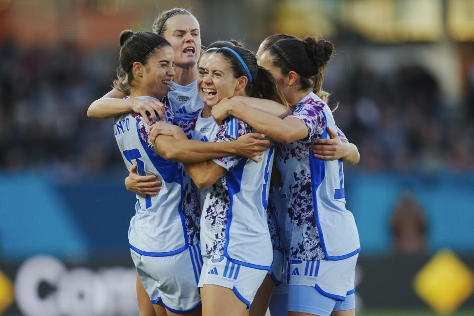 Spain's Aitana Bonmati, centre, celebrates with her teammates after scoring her team's first goal during the Women's World Cup second round soccer match between Switzerland and Spain at Eden Park in Auckland, New Zealand, Saturday, Aug. 5, 2023. (AP Photo/Abbie Parr)