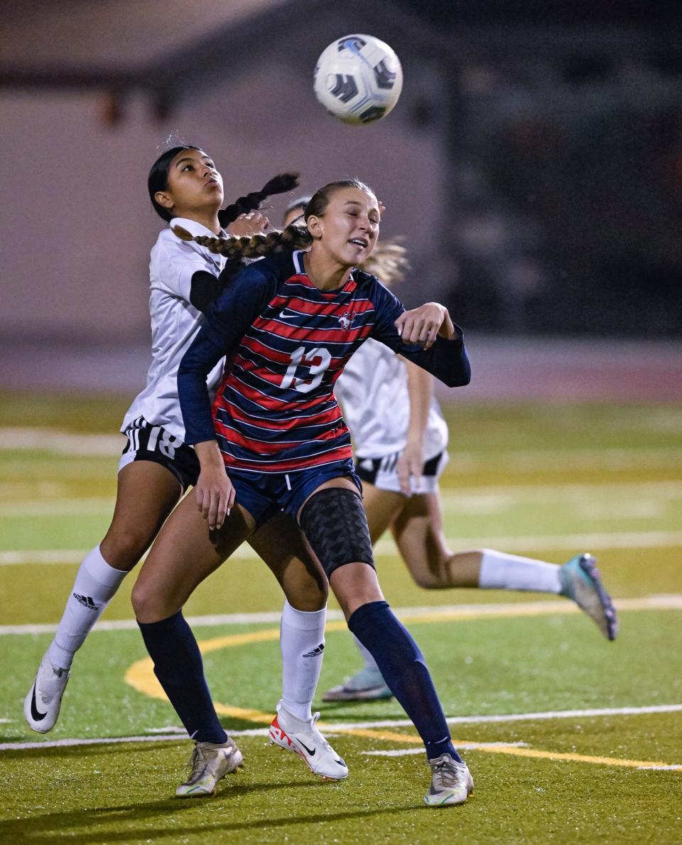 Tulare Western's Lauren Starr and Tulare Union's Michelle Saldivar get under a ball in a West Yosemite League high school girls soccer match Wednesday, January 24, 2024.
