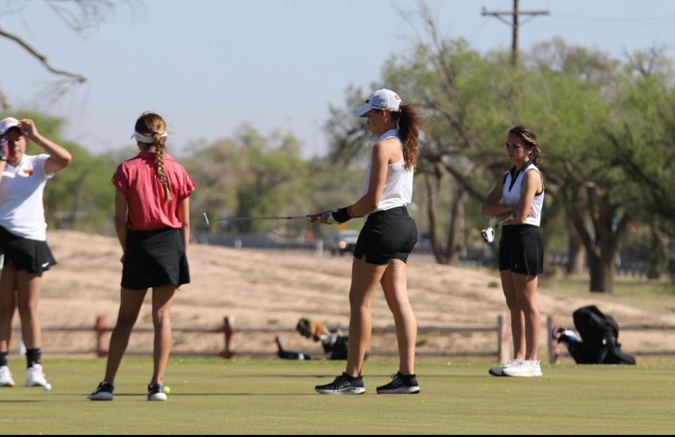 Memphis' Maggie Cook (center) readies to start her day at the golf course in 2023.