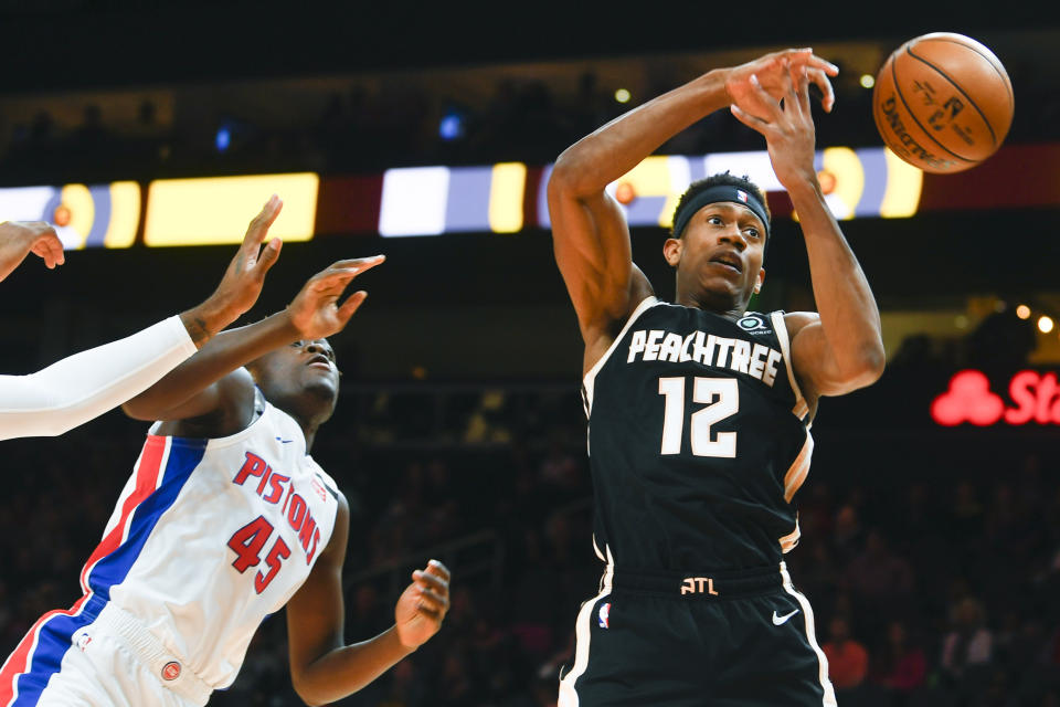 Atlanta Hawks guard Treveon Graham (12) loses control of a rebouind as Detroit Pistons forward Sekou Doumbouya defends during the first half of an NBA basketball game Saturday, Jan. 18, 2020, in Atlanta. (AP Photo/John Amis)