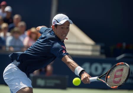 Jul 30, 2016; Toronto, Ontario, Canada; Kei Nishikori of Japan attempts to return a ball during the semi final match against Stan Wawrinka of Switzerland (not pictured) during the Rogers Cup tennis tournament at Aviva Centre. Kei Nishikori of Japan won 7-6, 6-1. Mandatory Credit: Nick Turchiaro-USA TODAY Sports